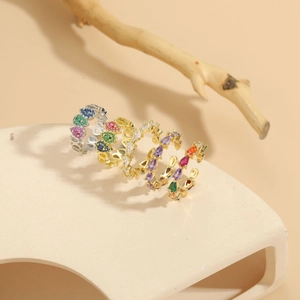 Detail of pear-cut colorful zircon rings with 14K gold plating on an artistic display