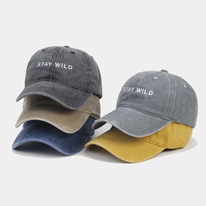 Detail showing various colors of vintage washed baseball caps with Stay Wild embroidery