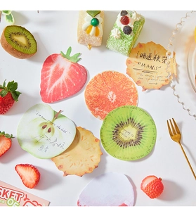 Flat lay of fruit-shaped sticky notes including strawberry and orange designs for journaling