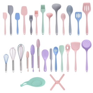 Multi-colored silicone kitchen utensil set including spatulas and whisks on white background