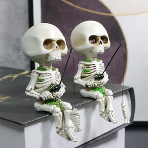 Detailed view of resin fishing skeleton figurines with moss accents on a book