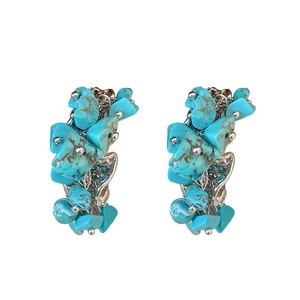 Sliver irregular C-shape hoop earrings with blue stones on a clean white background