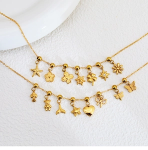 Detail of gold stainless steel necklaces with mini flower butterfly and heart charms