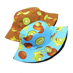 Reversible kiwi print bucket hats in light blue and brown for sun protection