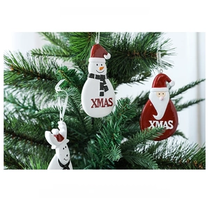 Hanging resin XMAS ornaments featuring Santa and snowman on a green Christmas tree