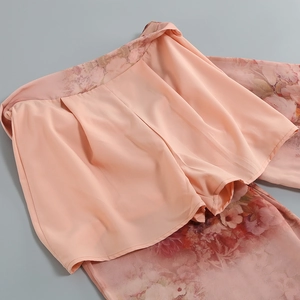 Detail of pink floral chiffon fabric with double-layer design and exquisite stitching