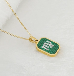 Macro shot of Virgo zodiac pendant in gold with malachite and white rhinestones