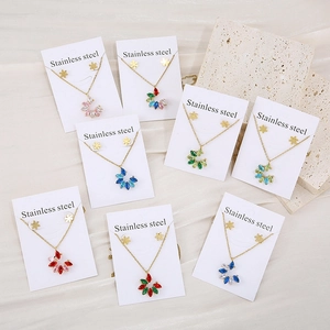 Elegant gold stainless steel jewelry set featuring colorful floral pendant necklaces and studs