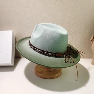 Detail of felt fedora hat featuring rhinestone woven band and green gradient texture