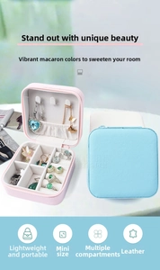 Macro detail of portable pink and blue jewelry box with velvet lining and partitions