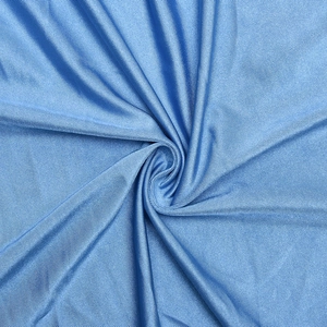 Macro detail of blue ribbed fabric showing texture and subtle sheen of the long dress