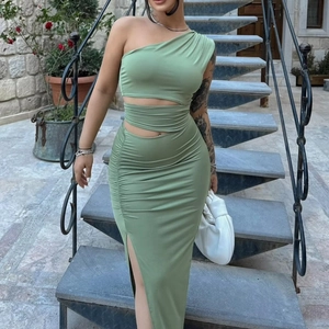 Close-up of ruched fabric texture and cutout waist detail on green slim bodycon dress