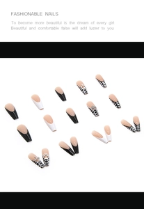 Detailed view of long coffin press-on nails with black French tips and silver crosses