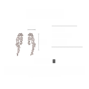 Macro detail of rhinestone leaf dangle earrings with streamline drop and silver finish