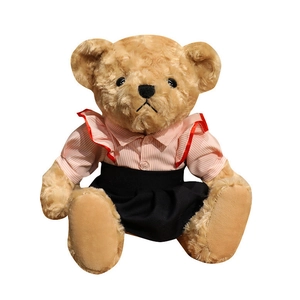 Cute teddy bear plush toy wearing pink striped shirt and black pleated skirt in sitting pose