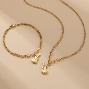 Golden double-layer chain jewelry set featuring guitar pendants on necklace and bracelet