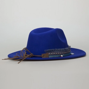 Detail of royal blue wool fedora with ethnic woven band and bohemian tassel trim