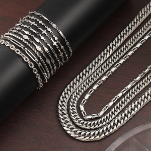 Detailed view of silver stainless steel geometric link chain necklace and bracelet set