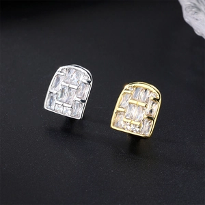 Macro shot of gold and silver hip hop tooth grillz with micro-pave cubic zirconia stones