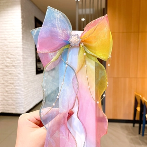 Rainbow organza bow hair clip with gold edges, pearl rhinestones, and hanging tassels