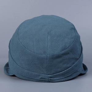 Detail view of the breathable dark blue cotton-linen fabric and textured short brim on the hat