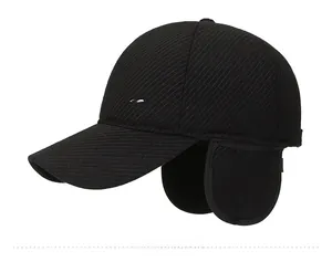 Detail of winter baseball cap with ear flaps and silver fashion metal emblem side view
