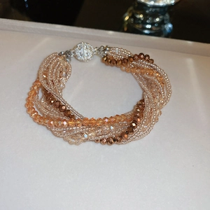 Detail of multi-strand beaded necklace with champagne crystals and crystal magnetic clasp