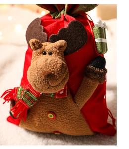 Detailed close-up of 3D reindeer Christmas gift bag with plush texture and knit scarf