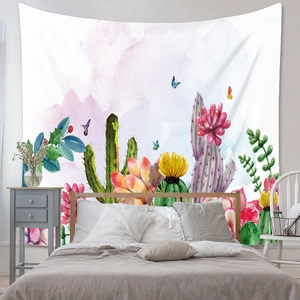 Detail of bohemian cactus tapestry with floral watercolor design on bedroom wall