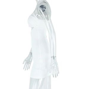 Detail of white bodycon dress showing side cut-out and high-stretch knit fabric