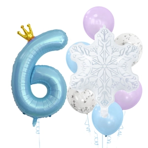 Detail of blue number 6 balloon with gold crown and white snowflake foil decorations