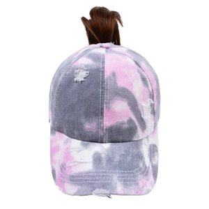 Detail of tie-dye baseball cap with distressed finish and functional ponytail opening