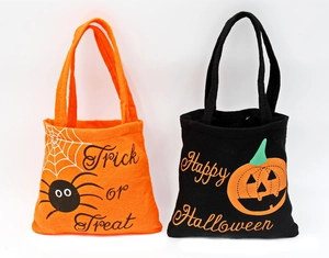 Halloween non-woven gift bags set with spider and pumpkin designs on white background