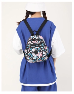 Floral nylon backpack for women shown on a model's back for size and style reference