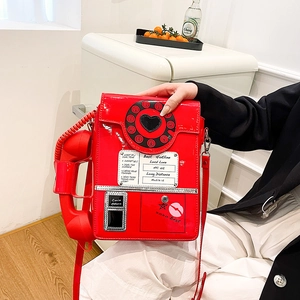 Retro red telephone-shaped crossbody bag with glossy finish and realistic handset