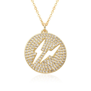 Macro shot of gold-plated lightning bolt circle pendant with sparkling cubic zirconia