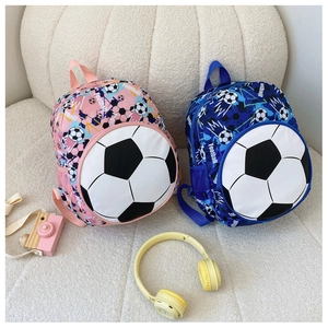Close-up of pink and blue soccer backpacks for kids with football themed 3D pockets