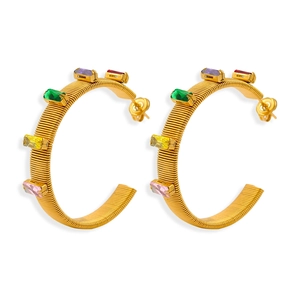 Golden C-shaped hoop earrings with colorful baguette-cut zircons and spiral texture