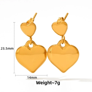 Detail view of gold double heart earrings with mirror finish and dimensions 23.5mm by 14mm