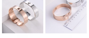 Detail view of 2cm wide minimalist spring-cuff bracelets in rose gold and silver finish