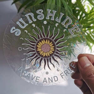 Macro view of holographic suncatcher sticker featuring sunflower and positive quotes