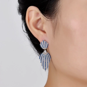 Luxurious S925 sterling silver leaf hoop earrings with blue stones on a model