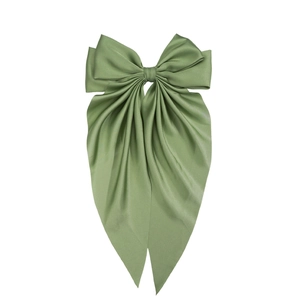 Detail shot of the glossy green satin texture and elegant bow design of the hair clip