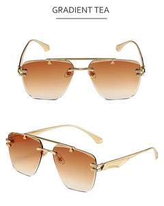Detail view showing gradient tea lenses and sleek gold metal temples of the rimless sunglasses