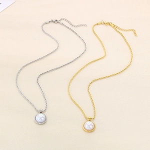 Gold and silver rope necklaces with star-engraved opal pendants on textured background