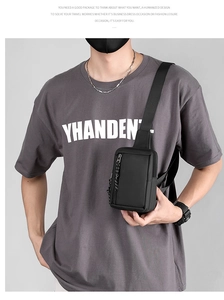 Detail view of water-resistant black crossbody chest bag with adjustable shoulder strap