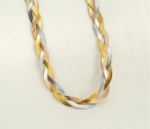 Macro detail of the tricolor braided titanium steel necklace in gold, silver, and rose gold