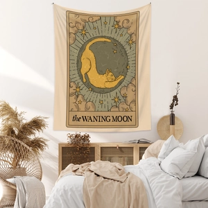 Detail of bohemian tarot tapestry featuring an orange cat and the waning moon design