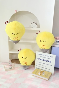 Three sizes of yellow cartoon light bulb plush pillows with cute embroidered expressions