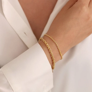 Detail of two layered 18K gold-plated rope chains showcasing textured spiral weave patterns